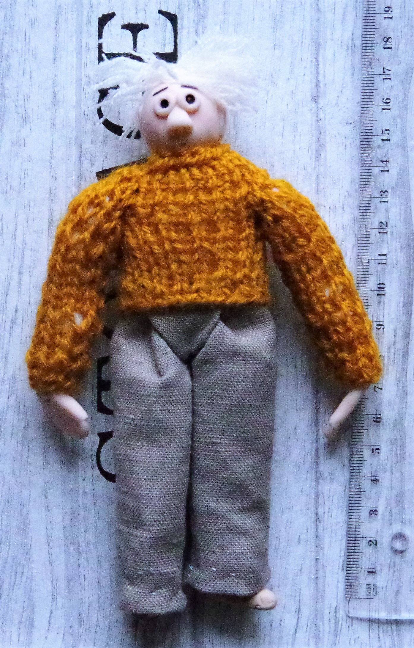 A rag doll. With a head, hands and shoes made of modelling clay.